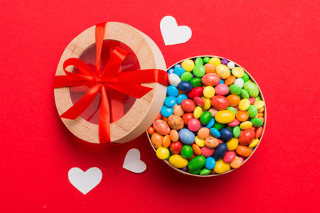 Valentine day composition: sweet candy, with gift boxes with and red felt hearts, photo bow template, background. Top View with copy space.の写真素材