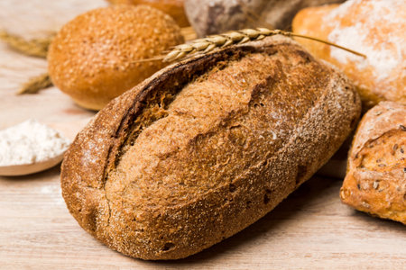 Homemade natural breads. Different kinds of fresh bread as background, perspective view with copy space.の写真素材