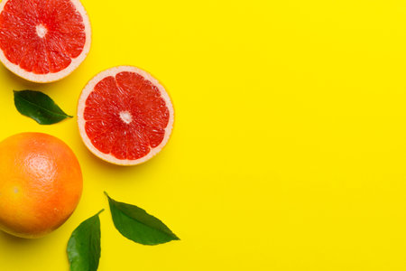 fresh Fruit grapefruit with Juicy grapefruit slices on colored background. top view. copyspace. creative summer concept. Half of citrus in minimal flat lay with copy space.の写真素材