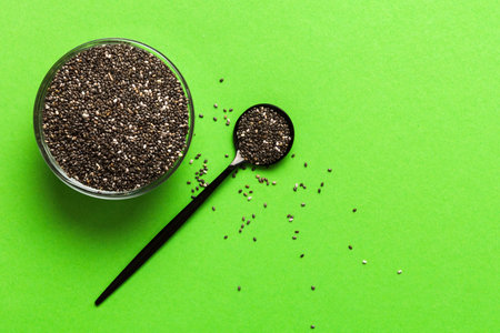 Chia seeds in bowl and spoon on colored background. Healthy Salvia hispanica in small bowl. Healthy superfood.の写真素材