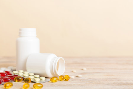 Pills and capsules on the table. Different colorful tablets at colored background with copy space.の写真素材