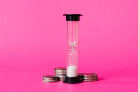 Deadline and time is money concept with hourglass and US coins currency. sand clock time for saving concept.の写真素材