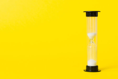 hourglass on the table, sand clock as time passing concept for business deadline, copy space.の写真素材