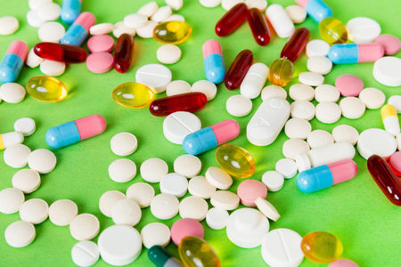 Many different colorful medications and pills perspective view. Set of many pills on colored...