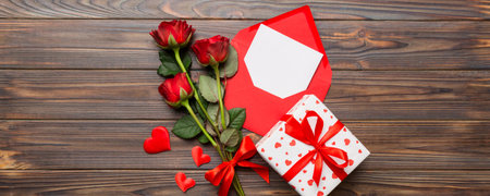 Valentine day composition with Envelope, rose flower and Red heart on table. Top view, flat lay. Holiday concept.の写真素材