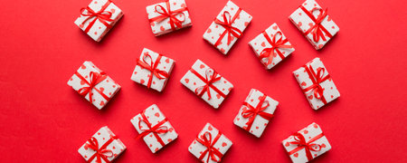 Valentine day composition Background: red gift box with bow and heart. Christmas present. View from...