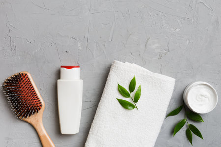 cosmetic for hair care, cream and towel on a colored background top view. flat lay.の写真素材