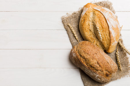 Assortment of freshly baked bread with napkin on rustic table top view. Healthy unleavened bread....