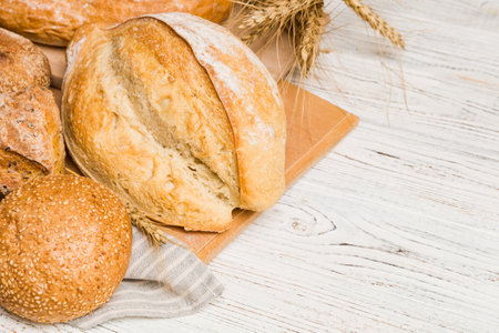 Homemade natural breads. Different kinds of fresh bread as background, perspective view with copy...