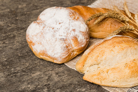 Homemade natural breads. Different kinds of fresh bread as background, perspective view with copy space.の写真素材
