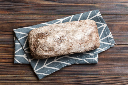Fresh rye bread on napkin on rustic background, fresh bread top view.の写真素材