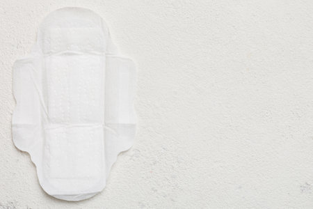 Women hygiene products or sanitary pad on colored background. Pastel color. Closeup. Empty place for text. Female daily hygiene.の写真素材