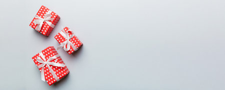 Valentine day composition: red gift box with bow and heart. Christmas present. View from above....