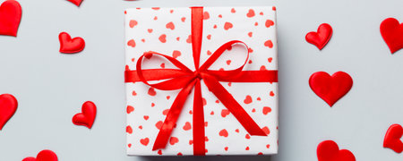 Valentine day composition Background: red gift box with bow and heart. Christmas present. View from above. Holday greeting card.の写真素材