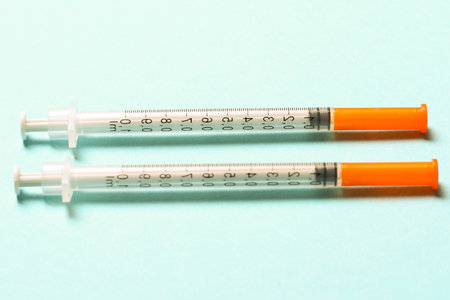 Top view of insulin syringes ready for injection on colorful background. Diabetic concept with copy...