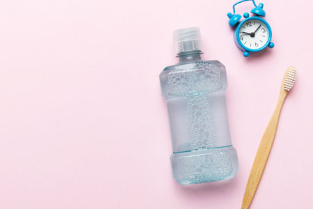 Mouthwash and other oral hygiene products on colored table top view with copy space. Flat lay. Dental hygiene. Oral care products and space for text on light background. conceptの写真素材