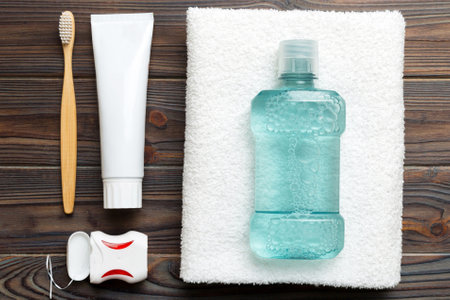 Mouthwash and other oral hygiene products on colored table top view with copy space. Flat lay. Dental hygiene. Oral care products and space for text on light background. conceptの写真素材
