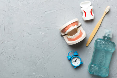 Mouthwash and other oral hygiene products on colored table top view with copy space. Flat lay. Dental hygiene. Oral care kit. Dentist concept.の写真素材