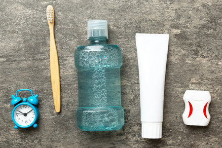Mouthwash and other oral hygiene products on colored table top view with copy space. Flat lay. Dental hygiene. Oral care products and space for text on light background. conceptの写真素材