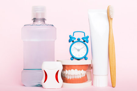 Mouthwash and other oral hygiene products on colored table top view with copy space. Flat lay....