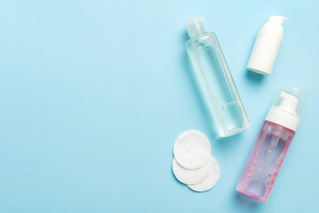 Micellar cleansing water and discs to remove cosmetics and cleanse the skin on colored background. Copy space top view.の写真素材
