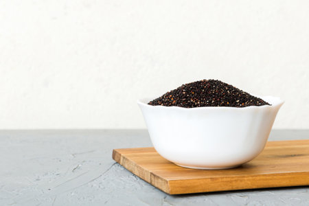 quinoa seeds in bowl on colored background. Healthy kinwa in small bowl. Healthy superfood.の写真素材