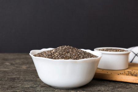 Chia seeds in bowl on colored background. Healthy Salvia hispanica in small bowl. Healthy superfood.の写真素材