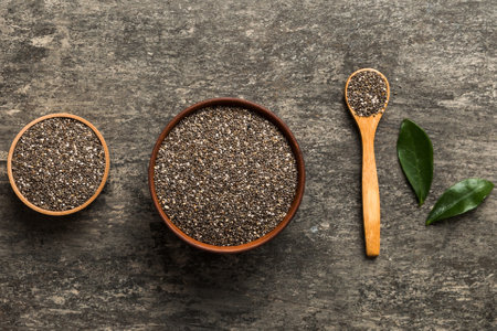 Chia seeds in bowl and spoon on colored background. Healthy Salvia hispanica in small bowl. Healthy superfood.の写真素材