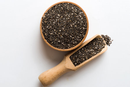 Chia seeds in bowl and spoon on colored background. Healthy Salvia hispanica in small bowl. Healthy superfood.の写真素材