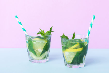 Mojito summer refreshing cocktail with ice and mint. mojito cocktail with lime, lemon and mint in a tall glass with a stick.の写真素材