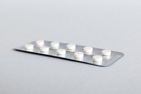 Blister package with aspirin on color background. Medicine pills on a light background. Medicines...