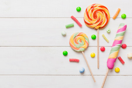 Tasty appetizing Party Accessories Happy Birthday Sweet. Different types of candies on colored background, copy space. Colorful birthday party background.の写真素材