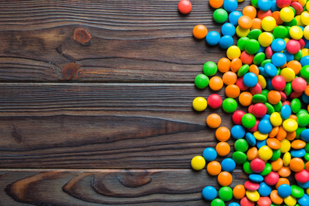 Mixed collection of colorful candy, on colored background. Flat lay, top view. frame of colorful chocolate coated candy.の写真素材