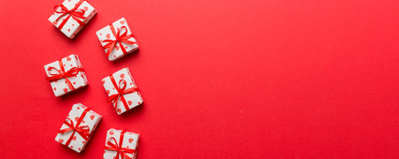 Valentine day composition: red gift box with bow and heart. Christmas present. View from above. Space for text. Holday greeting card.の写真素材