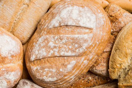 Homemade natural breads. Different kinds of fresh bread as background, top view with copy space.