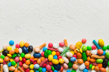 Mixed collection of colorful candy, on colored background. Flat lay, top view. frame of colorful...