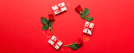 Heart made of rose, git box, heart and blank greeting card mockup on Colored background. Top view,...