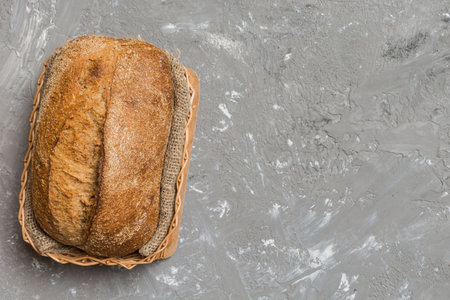 Freshly baked bread on basket against natural background. top view copy space.
