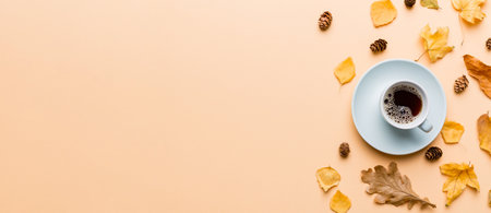 Flat lay composition with colorful Autumn cup of coffee and leaves on a color background. top view.の写真素材
