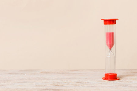 hourglass on the table, sand clock as time passing concept for business deadline, copy space.