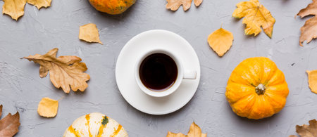 Flat lay composition with colorful Autumn cup of coffee and leaves on a color background. top view.
