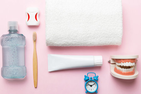 Mouthwash and other oral hygiene products on colored table top view with copy space. Flat lay. Dental hygiene. Oral care kit. Dentist concept.の写真素材