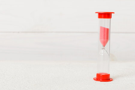 hourglass on the table, sand clock as time passing concept for business deadline, copy space.