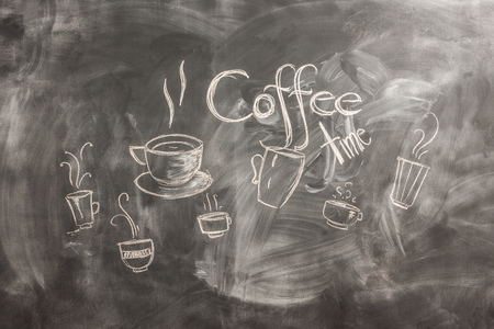 girl with coffee and phone looking at phone and smileの写真素材