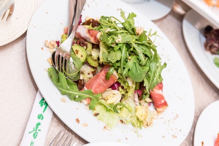 Salad with grilled vegetables and meat on plateの写真素材