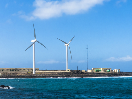 Wind turbines at a sea water osmosis production site, seafront Canary Islands.の写真素材