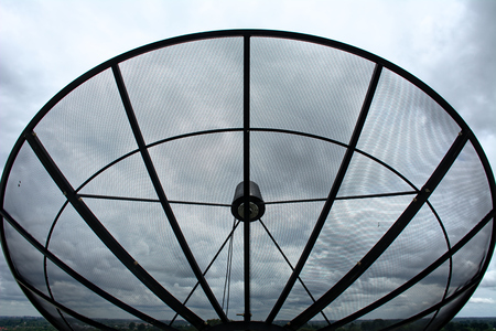 Satellite dish in cloudy dayの写真素材