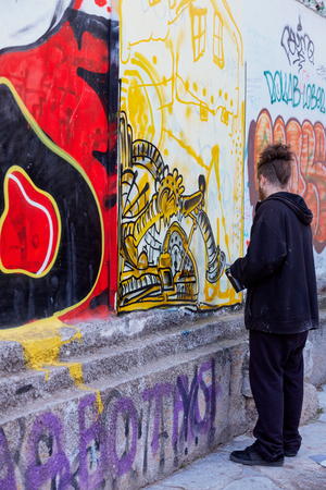 Graffiti artist create graffiti to the wall at Athens Greeceのeditorial素材