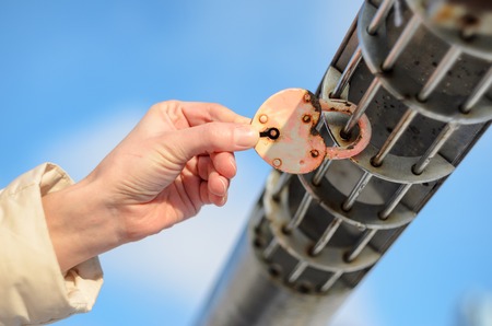 Padlock in the shape of a heart on the palm. Checking the strength of the conceptの写真素材