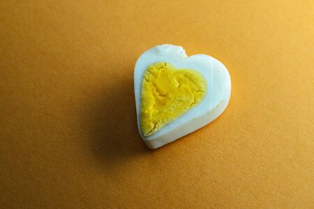 Egg heart on Yellow color background. Romantic background conceptの写真素材